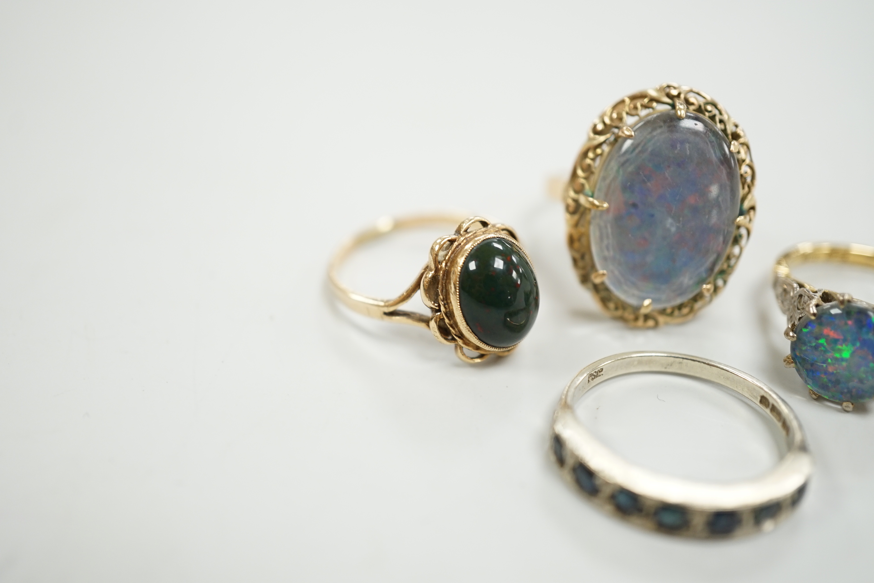 A 1940's 18ct and black opal doublet set dress ring, with diamond chip set shoulders, size L, a 14c and oval doublet ring and two other 9ct and gem set rings.